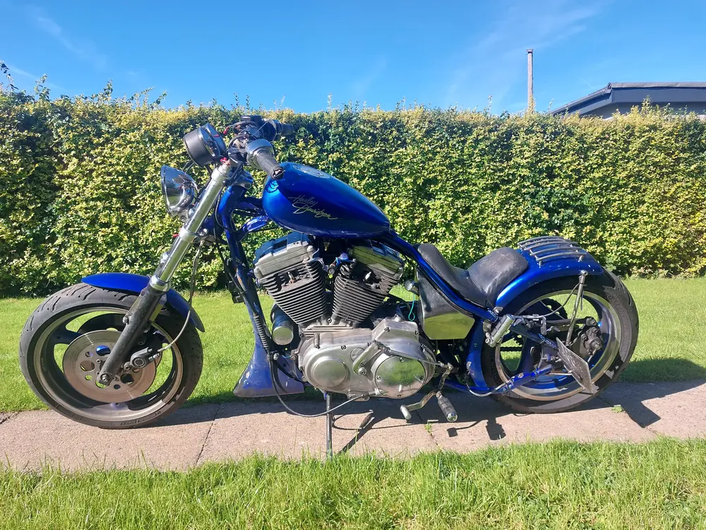 Blue custom hardtail chopper with long forks